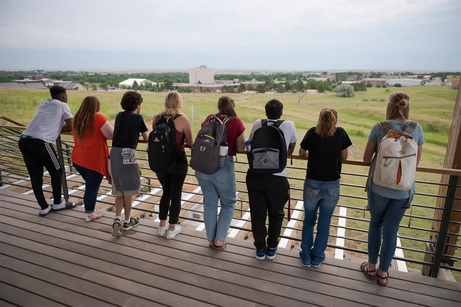 A group of students looking over a railing at the Rangeland Complex